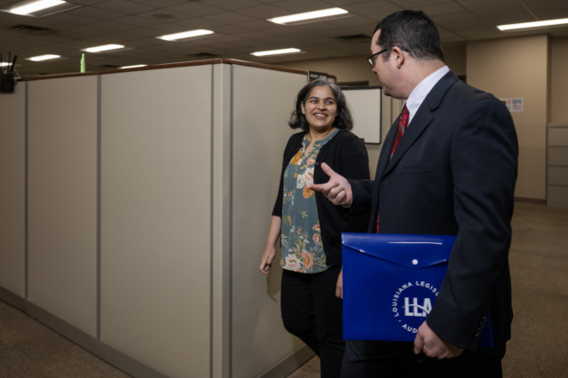 Auditors walking by cubicles