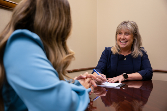Smiling auditors sitting at table